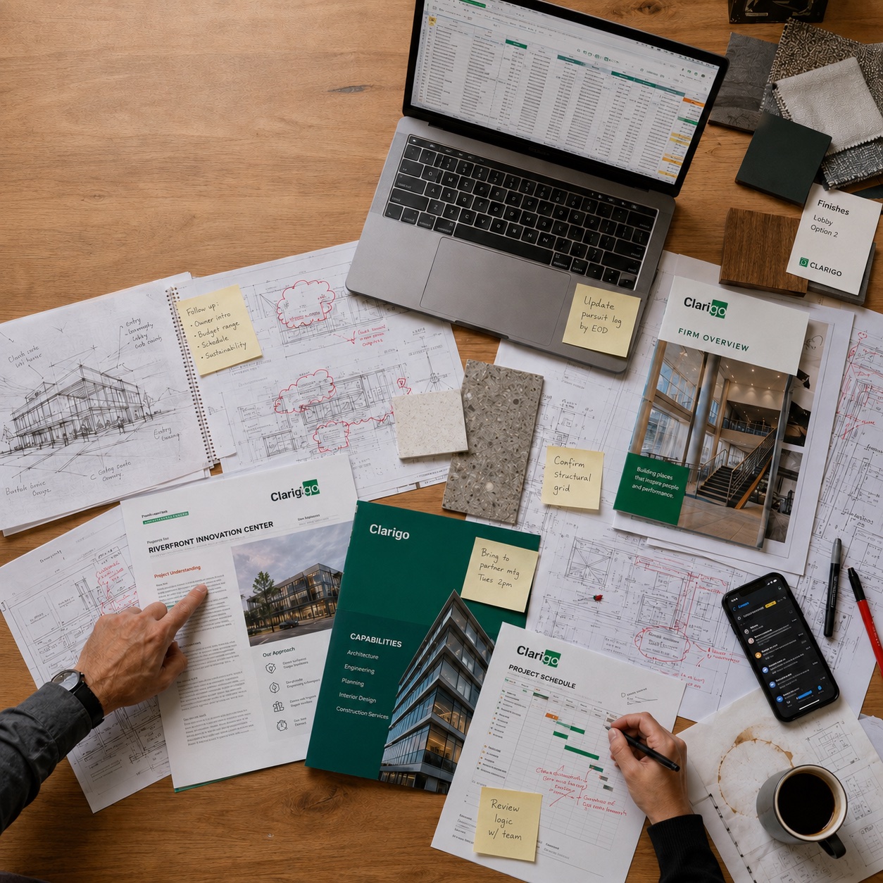 Scattered AEC and commercial real estate project plans, CRM data, notes, and marketing materials spread across a work table